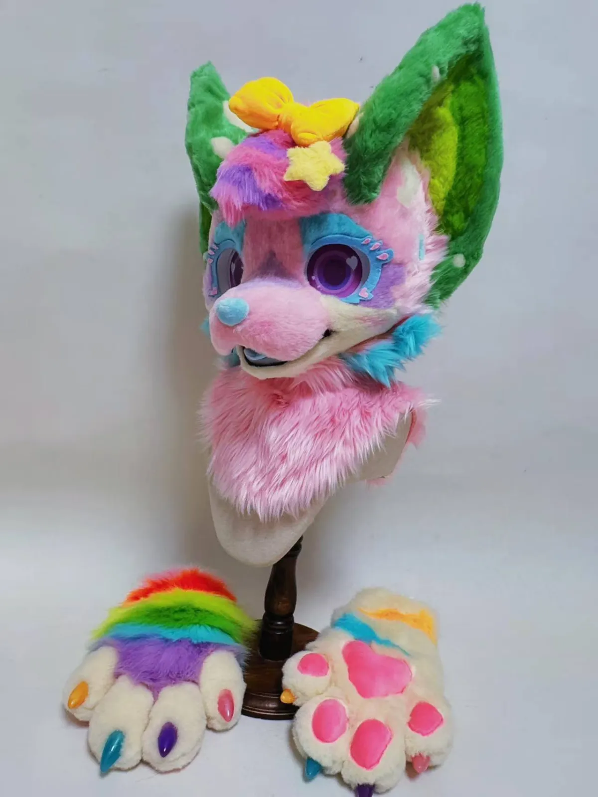 Pink & green candy fox fursuit with rainbow paws