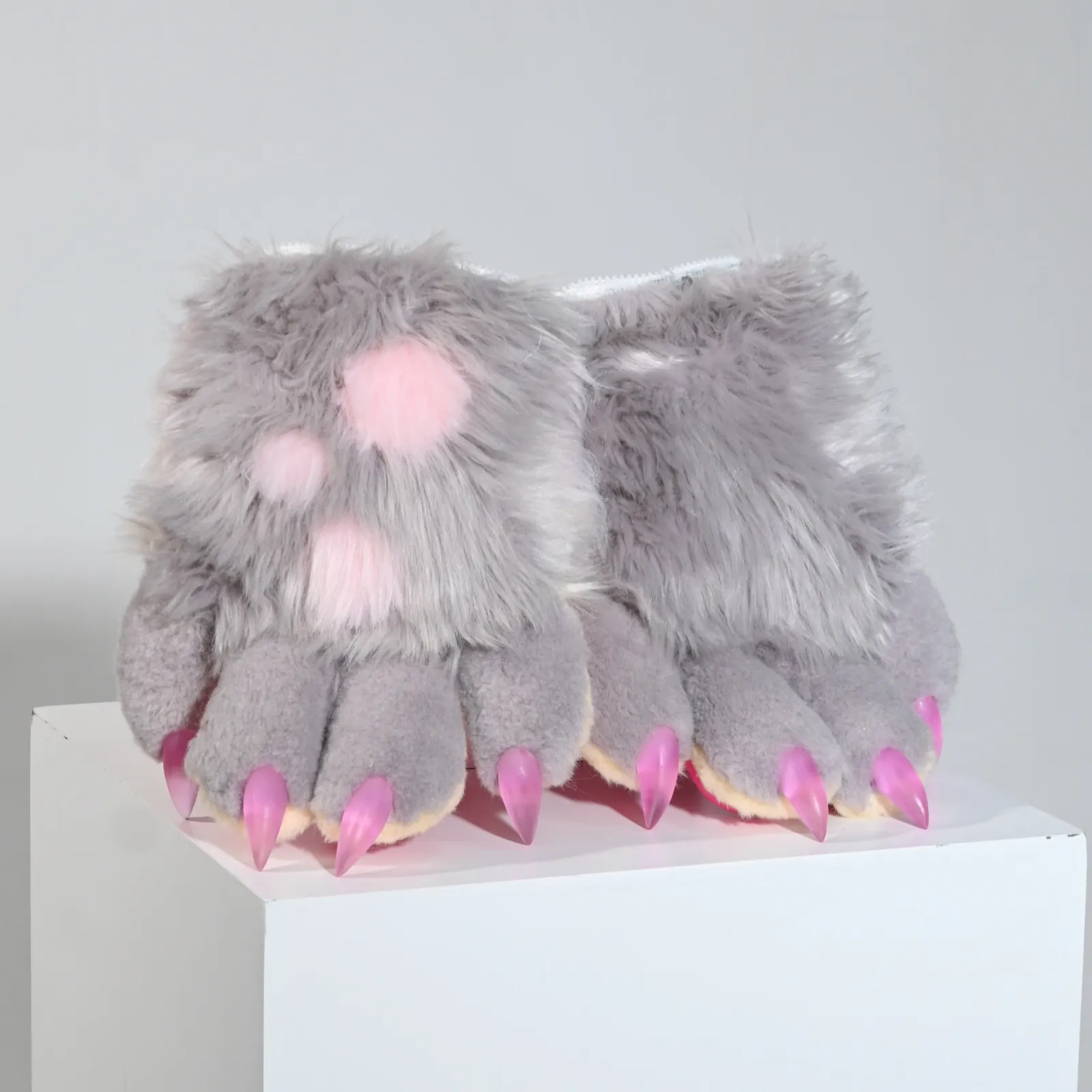Grey fursuit paws with pink pads and pink claws