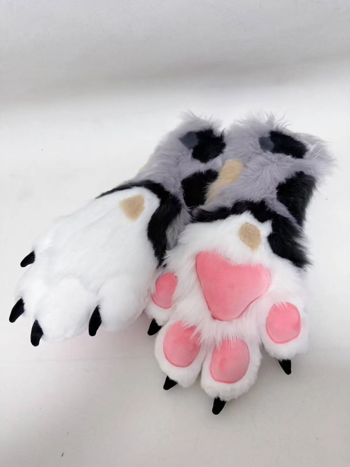 White, grey & black spotted paws with pink pads