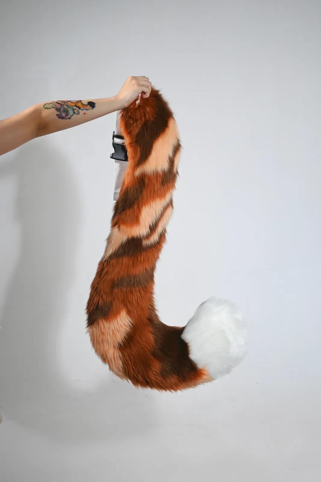 Orange, brown & white striped red-panda tail